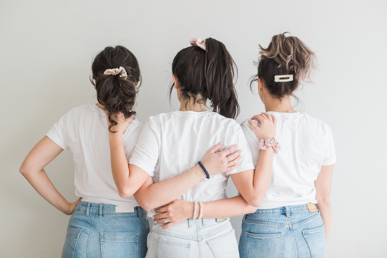3 models wearing mulberry silk accessories and pearl hair clips
